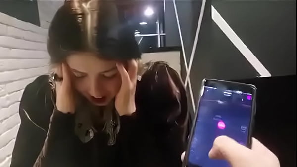 cute girl with remote vibrator in public