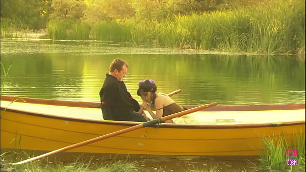 In the midst of a lake, a charming pair engaged in an outdoor activity on a compact watercraft  