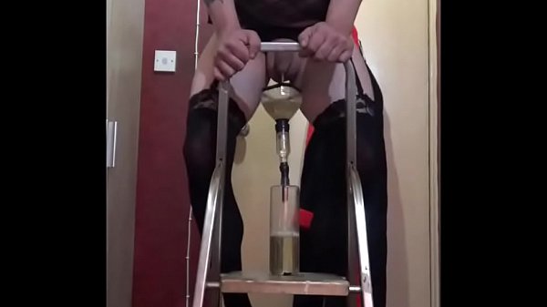 bisexual pissing in a bottle from a ladder