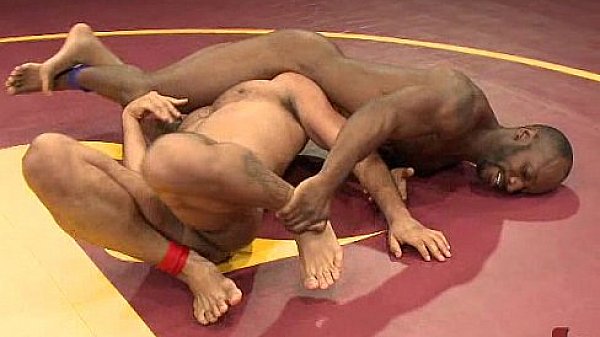 Two black gays wrestling and fucking on mats