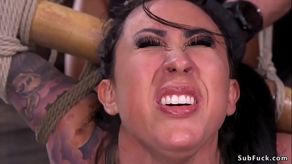 Gagged big tits alt brunette slave Lily Lane in strange spread bondage gets fingered then in backbend bondage tied up to a bamboo suspended