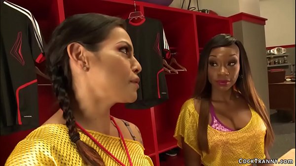 Brunette shemale coach TS Foxxy seduces hot big tits ebony Caramel Starr in lockers room and then with big cock fucks her pink twat 