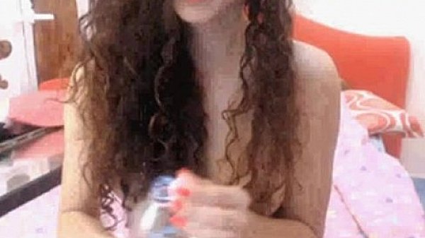 Curly brunette teen masturbates on webcam