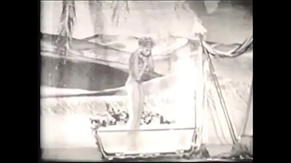 Cute blonde takes a bath in an old movie