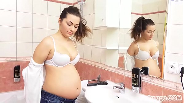 Missy pauses to admire her pregnant body in the bathroom mirror!  