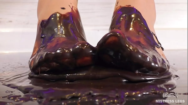 Goddess messy her nylon feet in chocolate close up and squeezing strawberries  