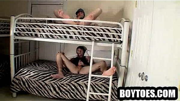 Two studs tugging on their cocks in a bunk bed 