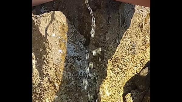 Horny girl with nice pussy peeing by the see  