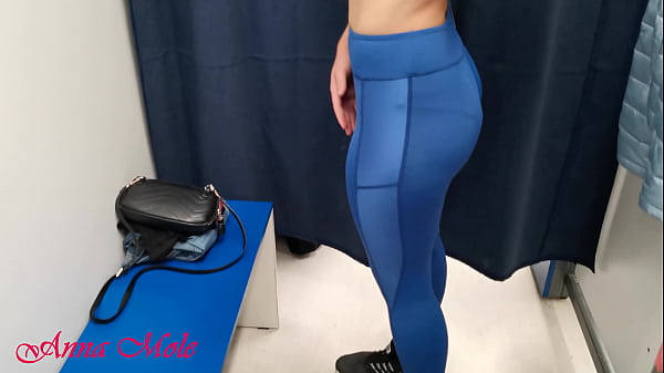 In the dressing room, a student tries on various pants for sports. Anna Mole
