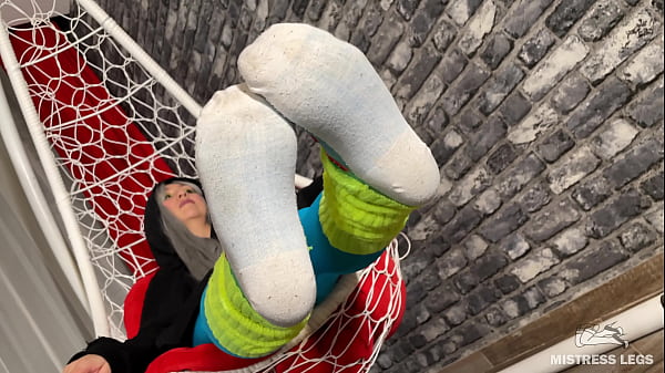 Long sexy legsand feet in blue nylons swings in a hanging chair above you