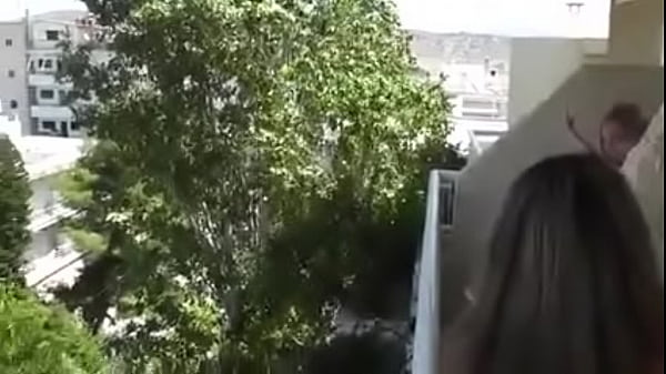 She talks with a neighbor and dildo masturbates on balcony