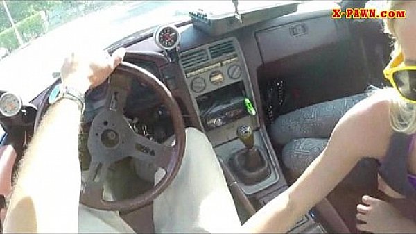 Blonde bimbo gives a road head while test driving her car