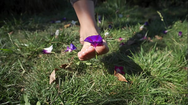 Sexy Feet With Long Toes Crushing Flowers Outdoors  