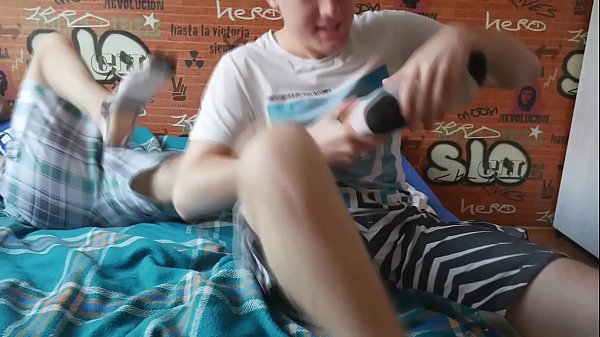 Two boys tickle each others feet and destroy their socks