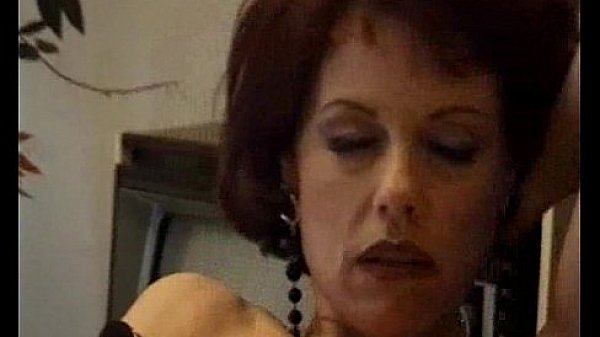 Two mature women masturbating on a couch