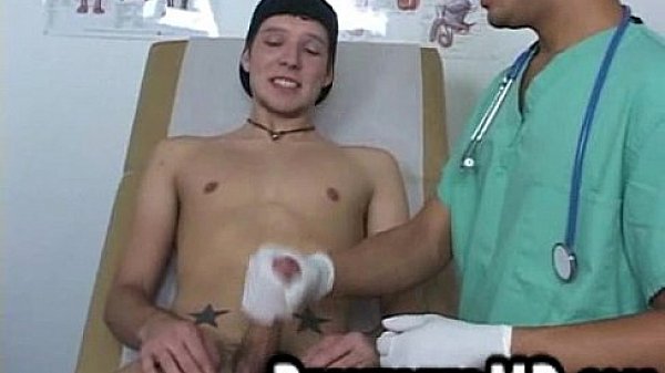 Sexy hunk patient has a toy put on his cock by the doctor
