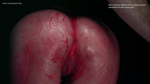 Violet Bee gets hooded and has her asshole injected with red enema mixture and pink enema goo  