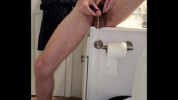 Pissing a trick shot into the toilet