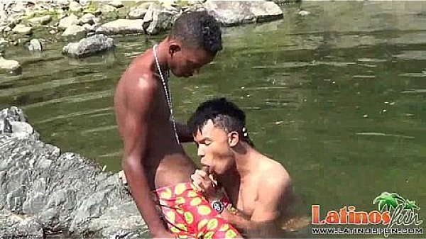 Teen gay swimmer playfully going down in the river