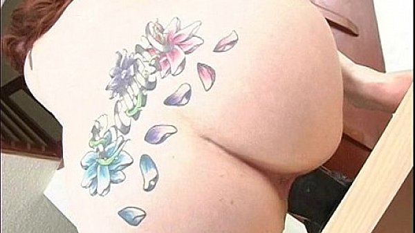 Pale redhead bounces up and down on a b. dildo