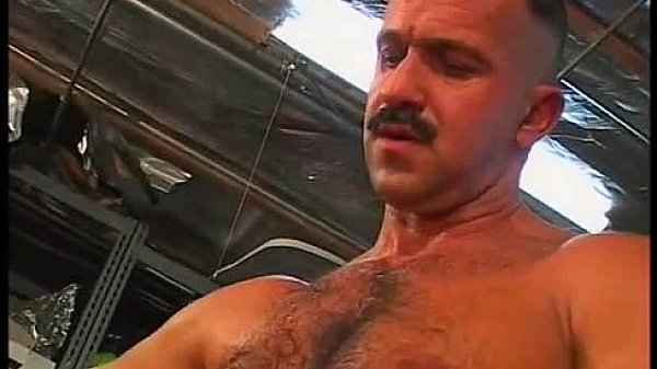 Hunk gets fucked hard anally by a mature stud