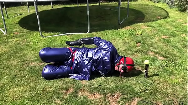 Hogtied in rain wear, rubber rain boots, hand cuffed inside ladies knee high boots  