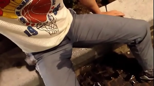 Selfpissing next to busy shopping       street