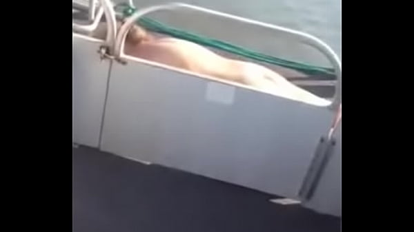 blonde MILF sun bathing Naked on pontoon boat