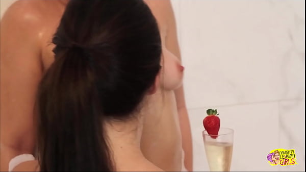 The attractive woman with brown hair plans a particularly provocative surprise for her female partner in the shower.