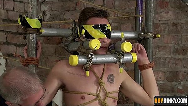 The boy is restrained in a cage of metal