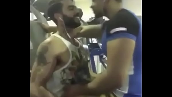 A couple of hot guys from India kissing each other passionately inside a gym