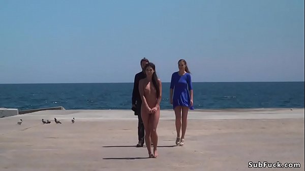 Mistress and sexy dark haired Spanish slave walked naked on dirty streets of Barcelona