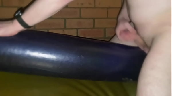 Masturbating on top of waterbed tube in rubber clothing