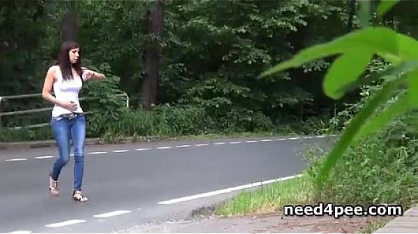 Brunette using a pass way as her own toilet