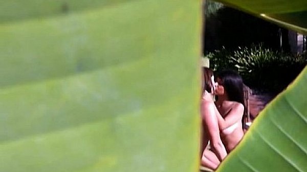 Two horny lesbos rub their pussies under the sun