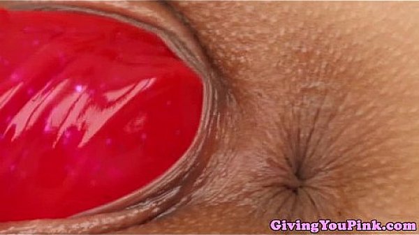 Moist pink dildo handling a pink dildo