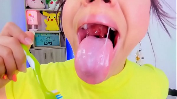 Lila Jordan uses a toothbrush to brush her teeth and tongue 