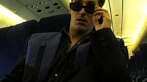 Brunette beauty wearing stewardess uniform gets fucked on a plane