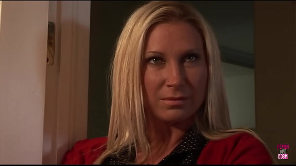 A man exercises control over a well-endowed blonde woman who is restrained in the restroom  