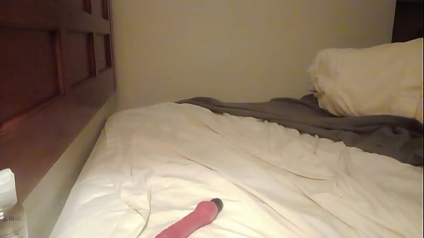 Trans woman plays with toy while cuffed  