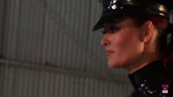 A seductive officer clad in a latex costume engages in intimate relations with an attractive woman with ample and aesthetically pleasing bosoms.