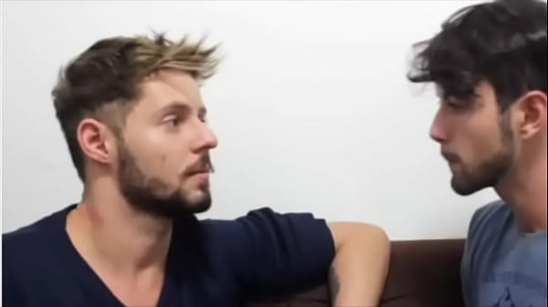 A couple of young guys kissing each other passionately