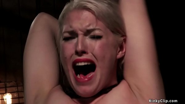 Shackled in metal device in sitting position with legs spreaded wide and arms behind back gagged blonde slave Ella Nova is caned then set on Sybian on device bondage  