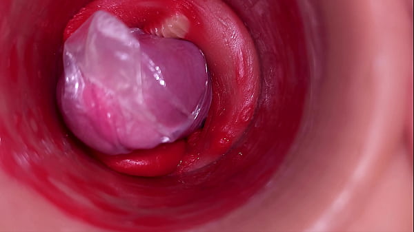 The camera inside the deep pussy records a huge ejaculation with a stuck condom
