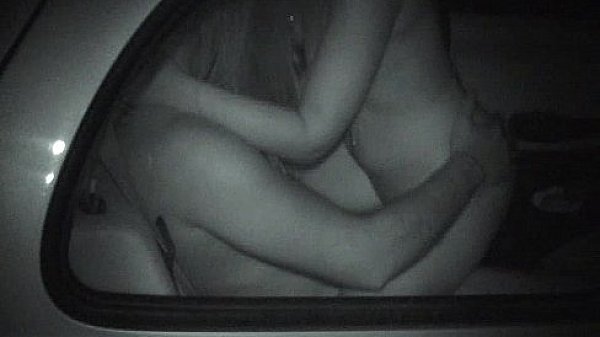 Two people in a small car have fun