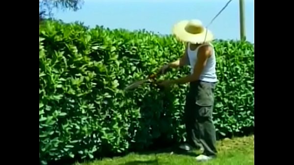 Stud with shaved head  lies on the grass to blow his boss groundskeeper 's hard pole 