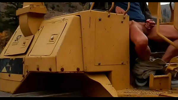 Playing with my cock sitting on a bulldozer  