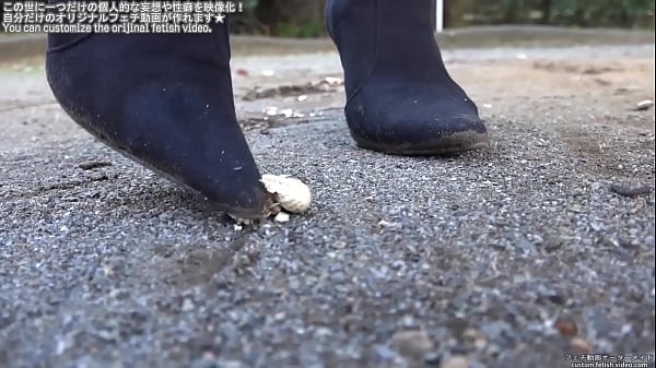 Woman trampling peanuts with legs