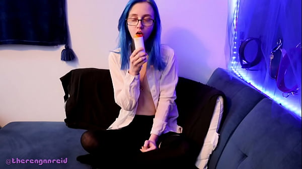 Emo punk girl sucks on a popsicle