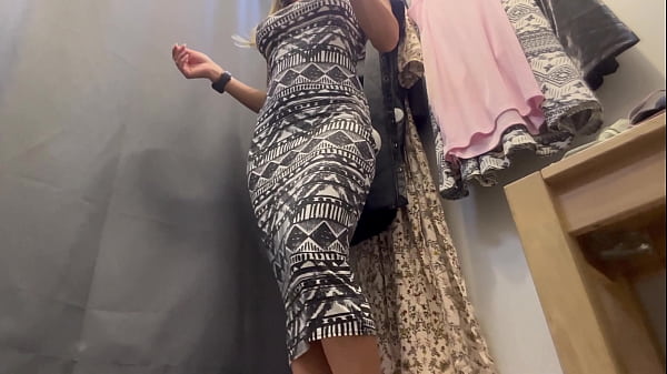 A sexy woman with big breasts and a big ass tries on clothes